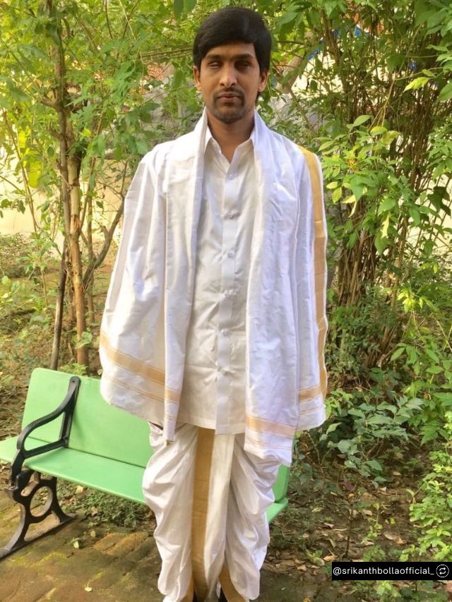 Bollant Industries Founder Srikanth Bolla Net Worth, Journey, Vision & Company Value 2 Srikanth Bolla, CEO of Bollant Industries, stands gracefully outdoors wearing traditional white Indian attire with gold trim.